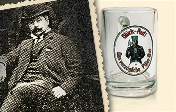 Ein Mann sitzt in einem Sessel und trägt einen Anzug und Hut. Rechts ist ein Glas mit einer Figur und Text darauf.